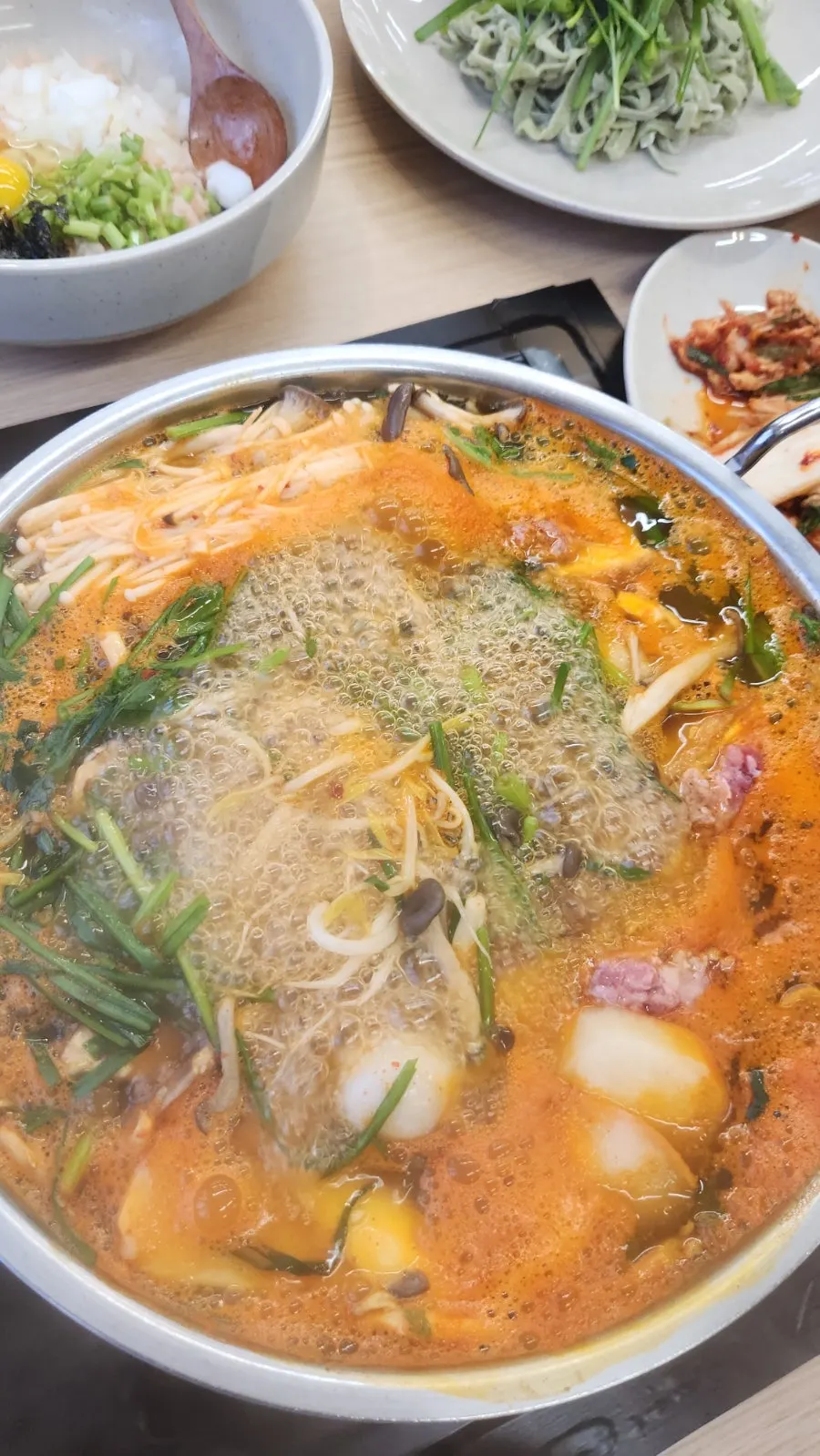 The signature broth simmering in the shabu-shabu pot