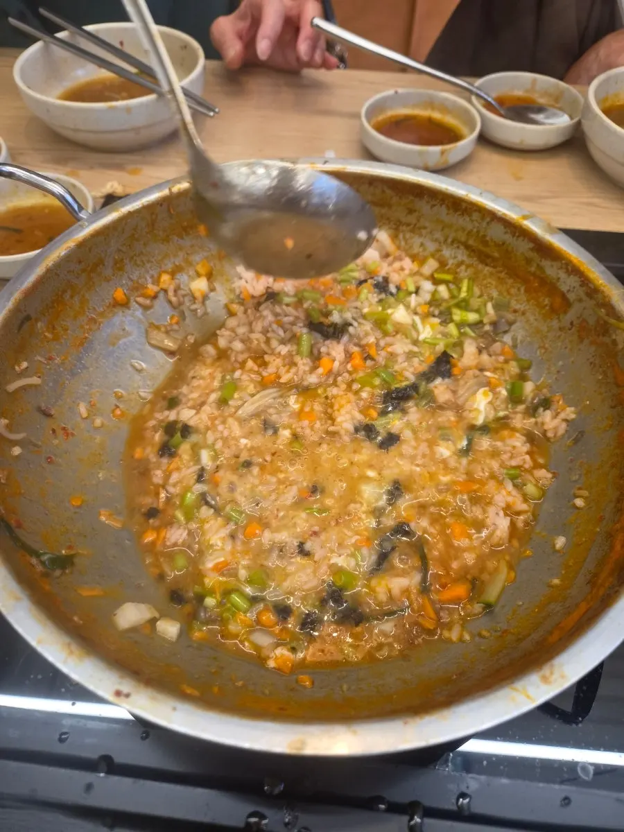 Porridge simmering in the leftover broth