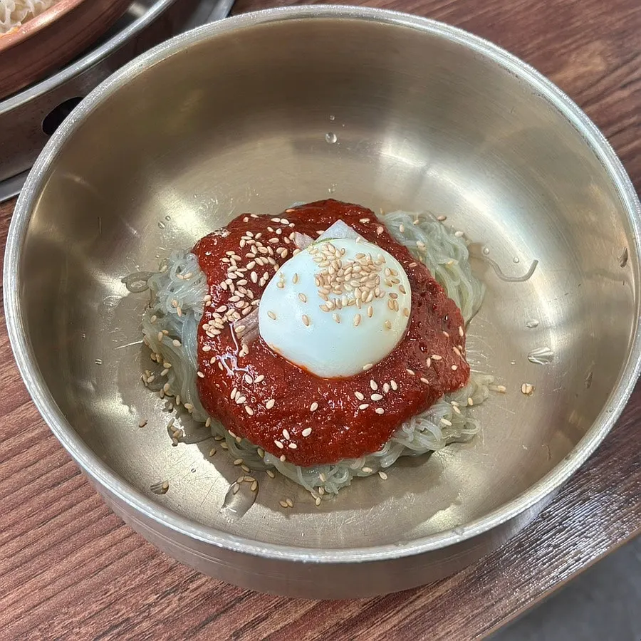 Noodles of the water naengmyeon topped with ice slush