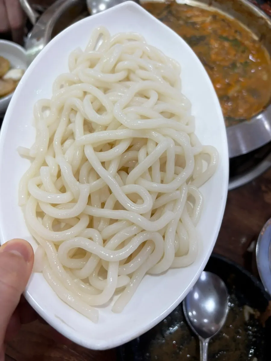 Udon noodles added to the hot pot broth