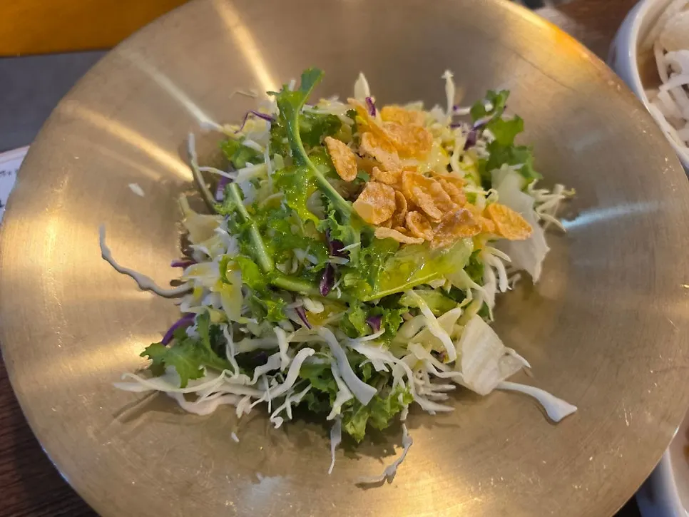 Table spread with mustard pickles and salad