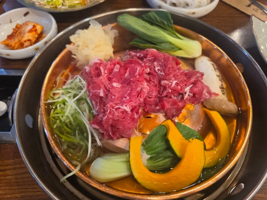 Grill with broth, vegetables, and Korean beef bulgogi