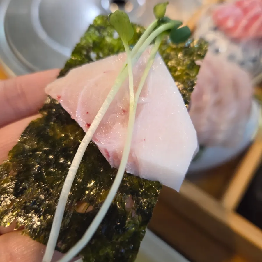 Raw fish dipped in chojang alongside the assorted platter