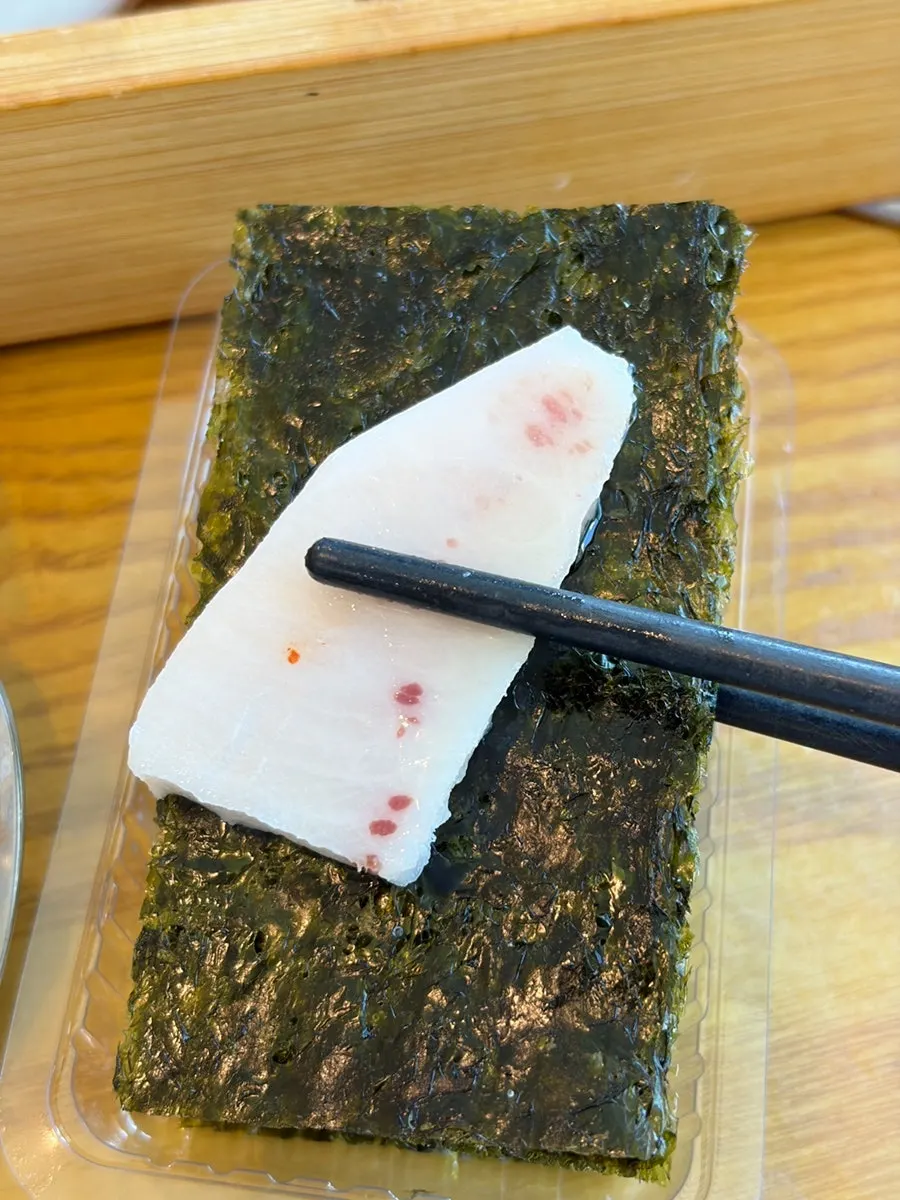 Sashimi wrapped in seaweed dipped in sesame oil