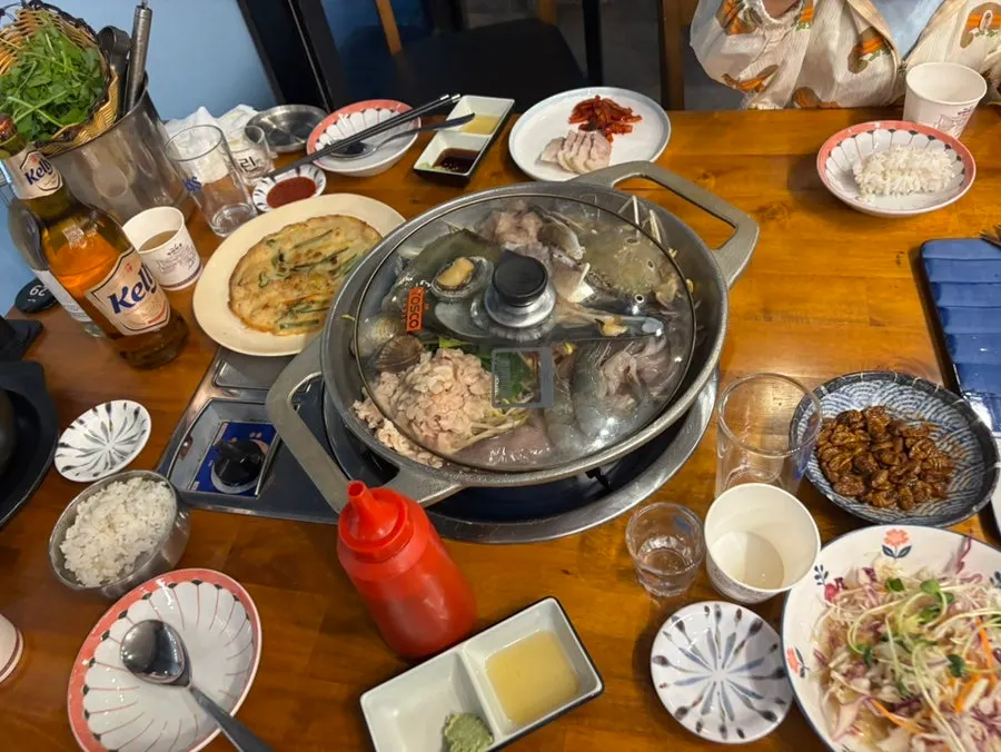 Table filled with the 110,000 won sashimi and seafood stew set