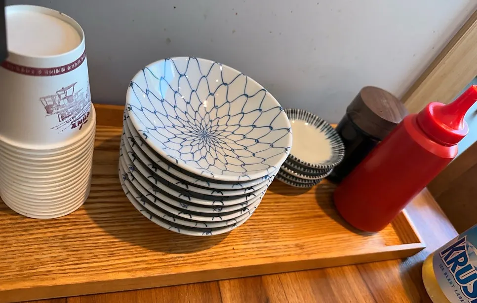 Table set with vinegar-gochujang sauce, soy sauce and small plates