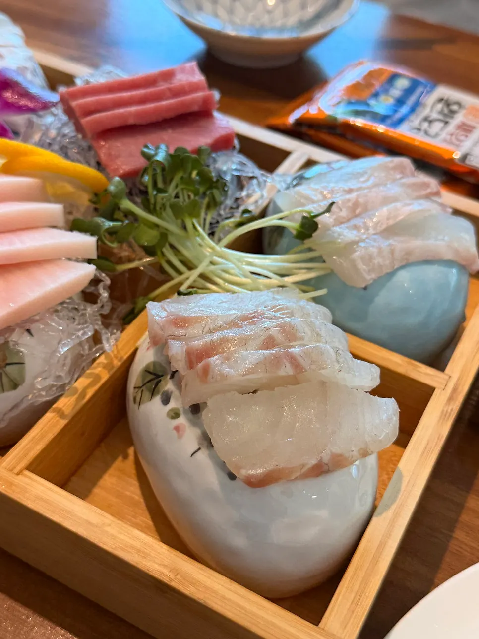 Sea bass, tuna and flounder sashimi platter on a tray