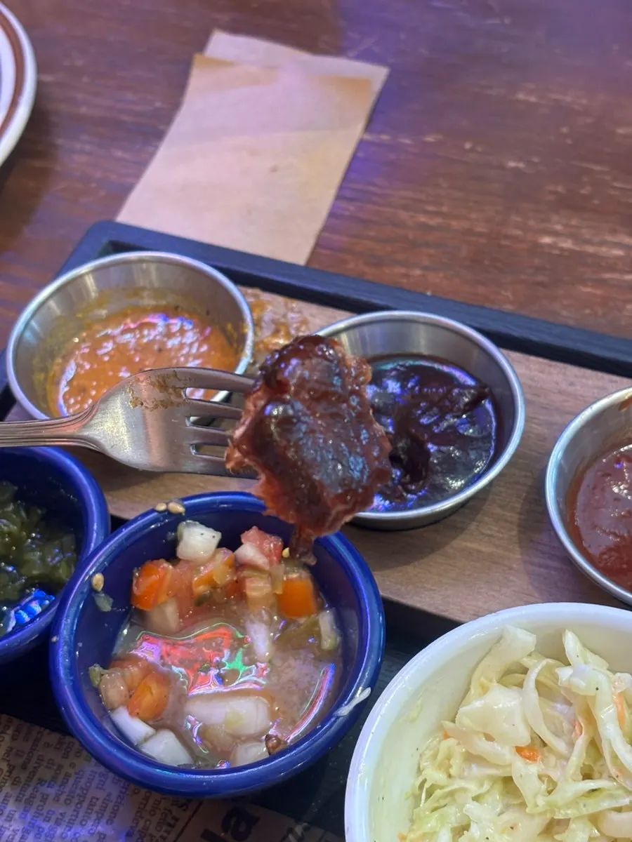 Dipping spare ribs into sauce