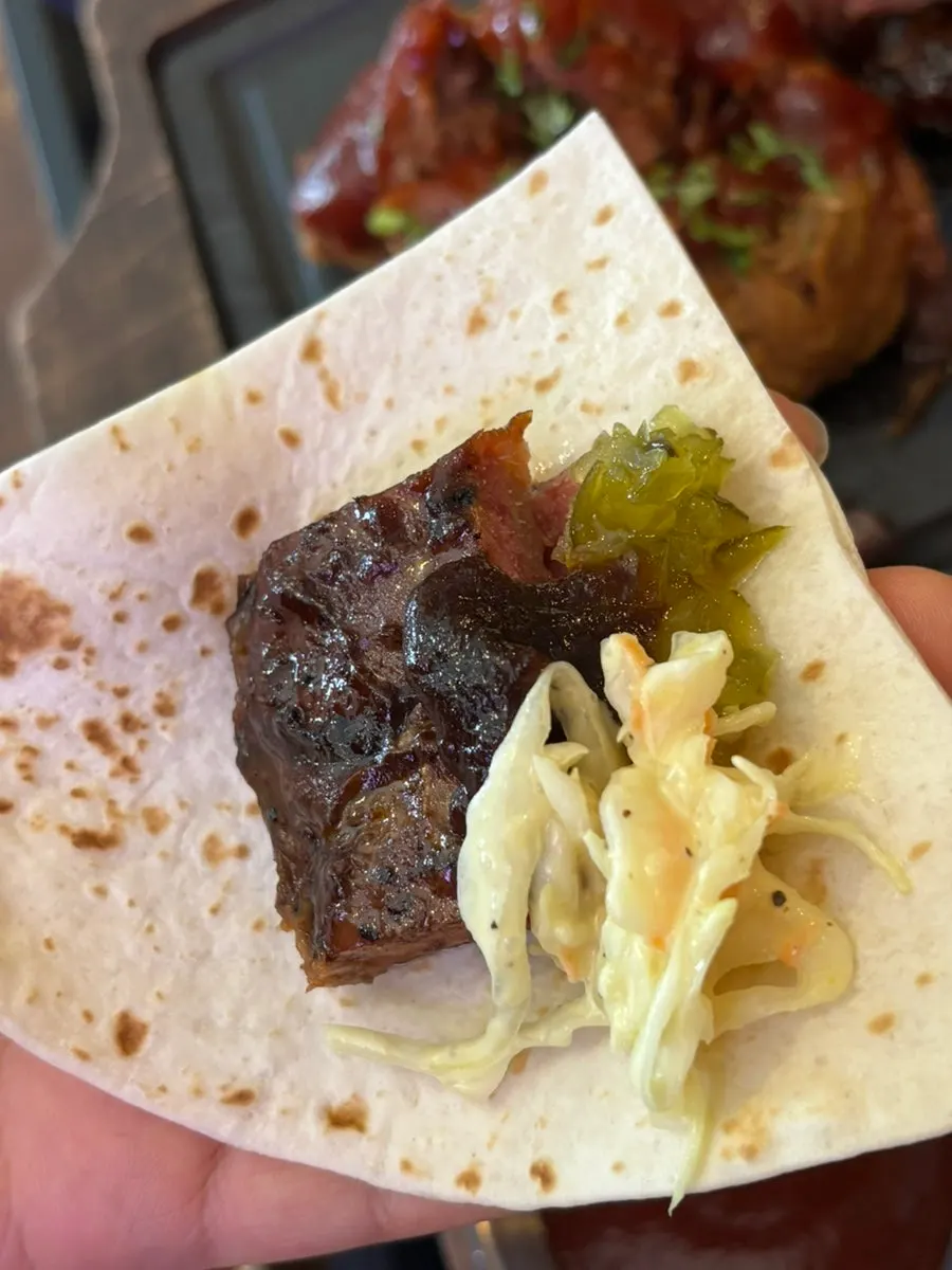 Meat and sauce combined on a tortilla
