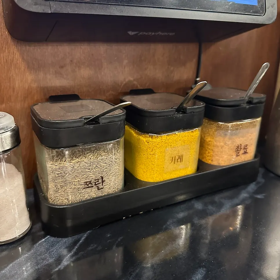 Salt, cumin, curry, and chuanliao seasonings for the lamb skewers