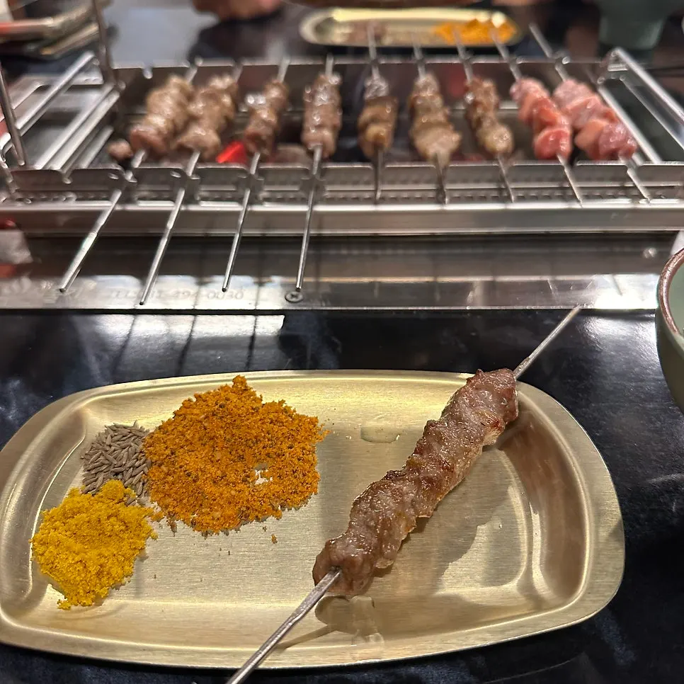 Lamb skewers grilled to a golden brown over charcoal
