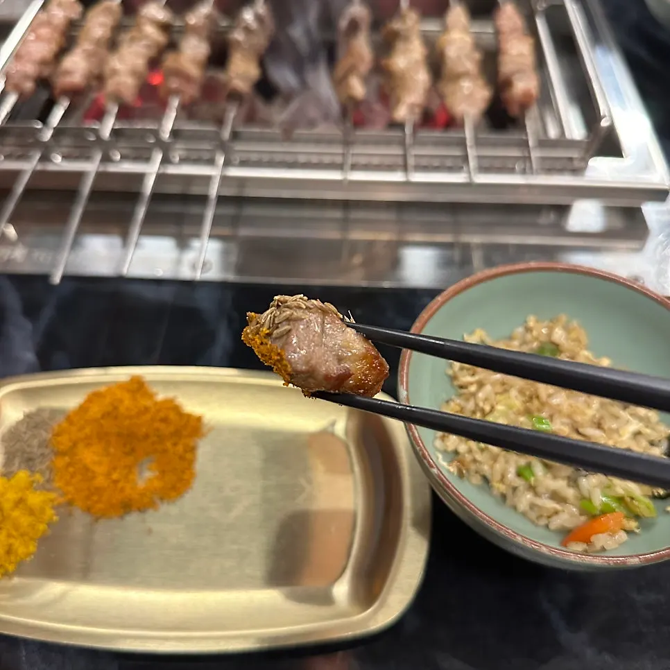Lamb pulled off the skewer with sauce on a small plate