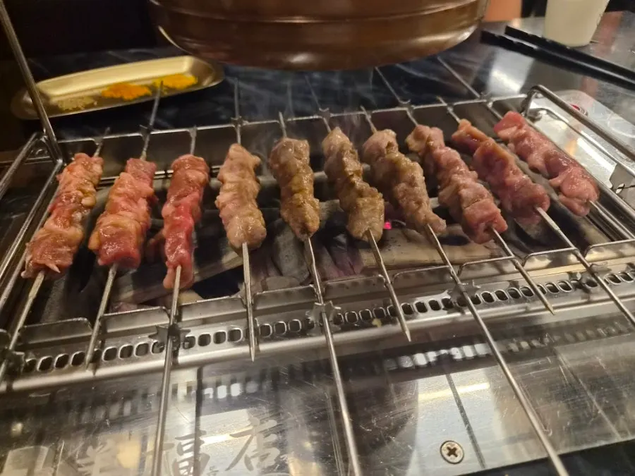 Lamb skewers set into a gear that spins them automatically