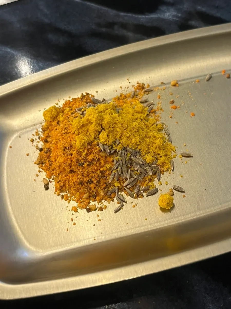 A sauce plate with curry, cumin, and chalryo mixed together