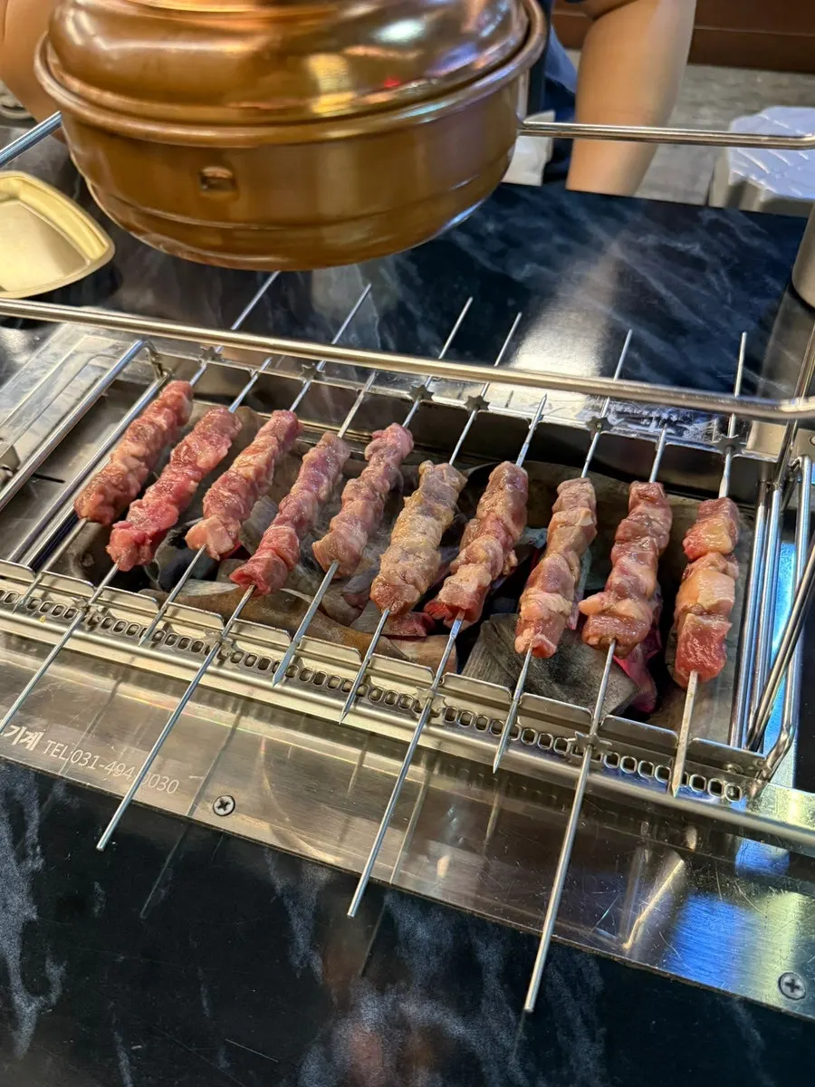 Skewers placed to fit the holes in the grill