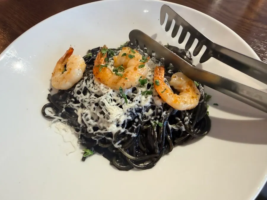A plate of shrimp squid ink pasta