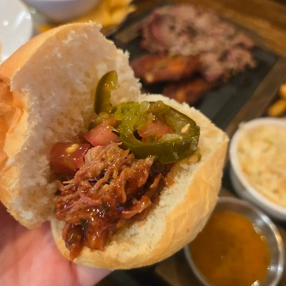 A bite of tortilla with coleslaw and sauce