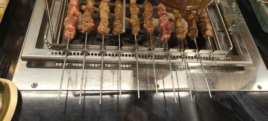 Handles of grilled giant lamb skewers