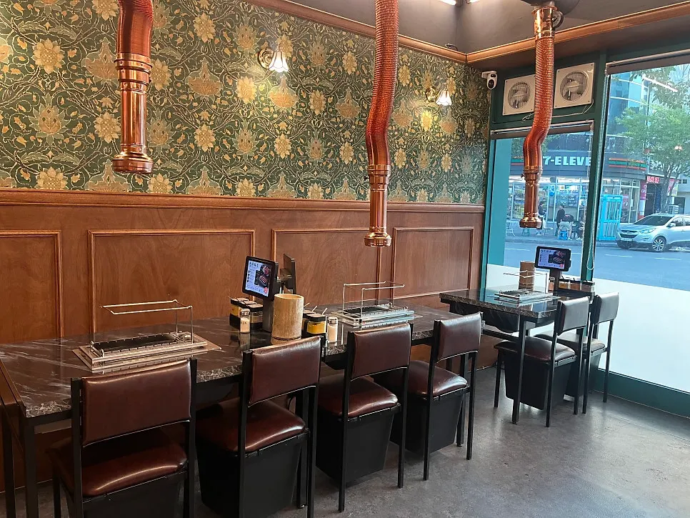 Interior of Yangbokjeom Dongdaegu Station Branch with wood-toned walls