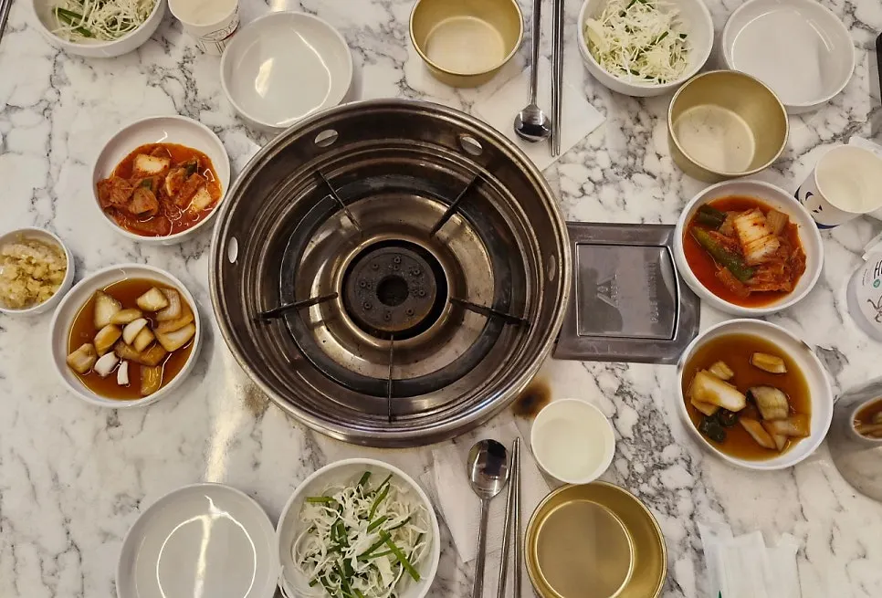 Bowl of pickled onions, kimchi and vegetables for the dipping sauce