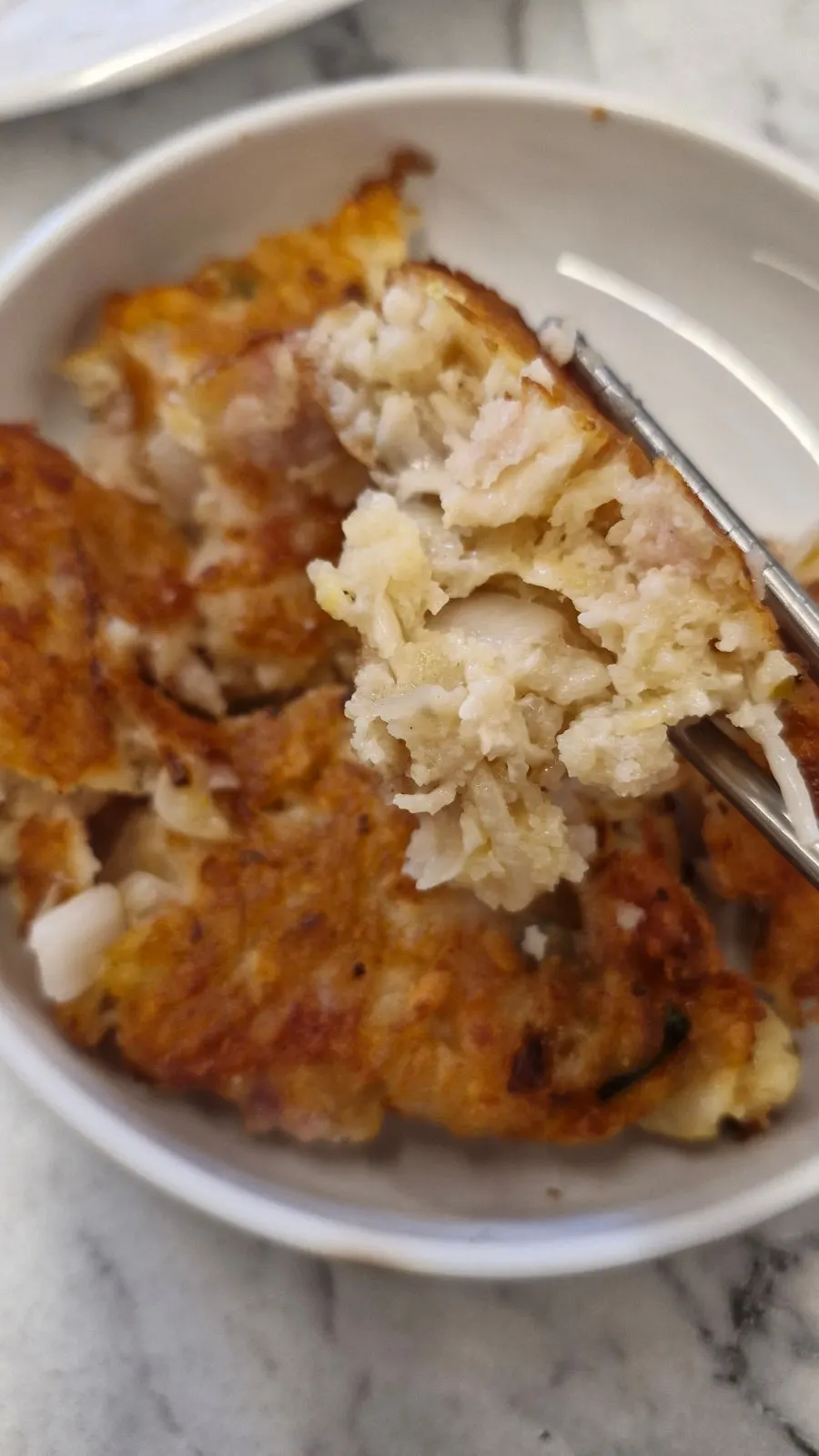 Cross-section of bindaetteok packed with meat