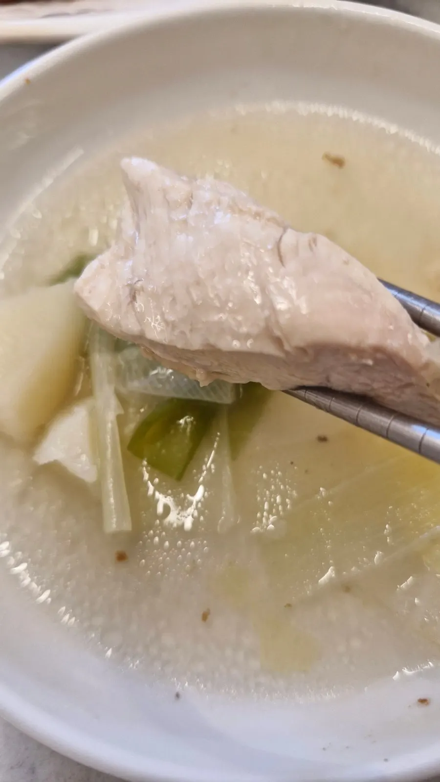 Tender chicken scooped out of the pot