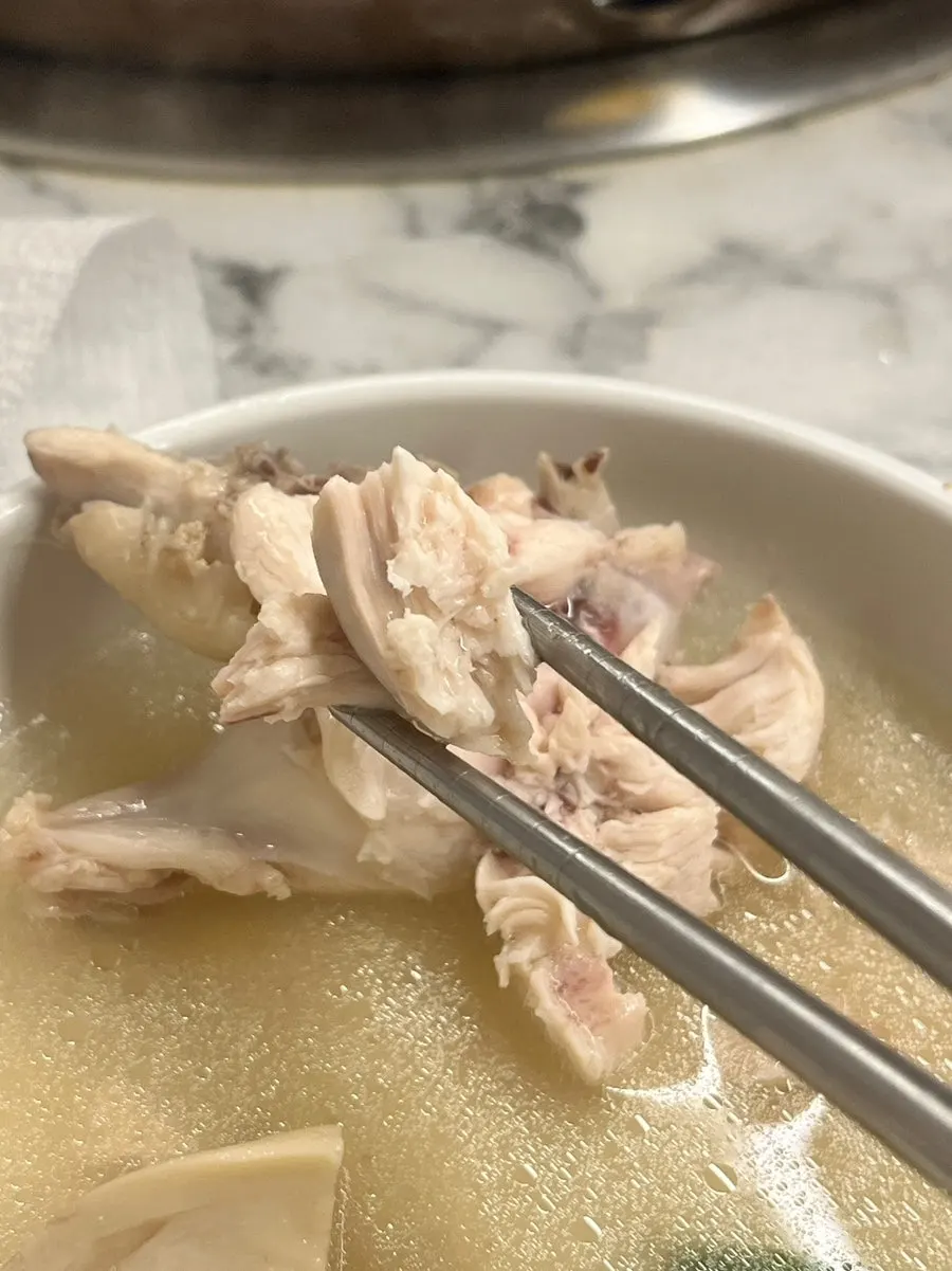 Individual bowl ladled with dak hanmari broth