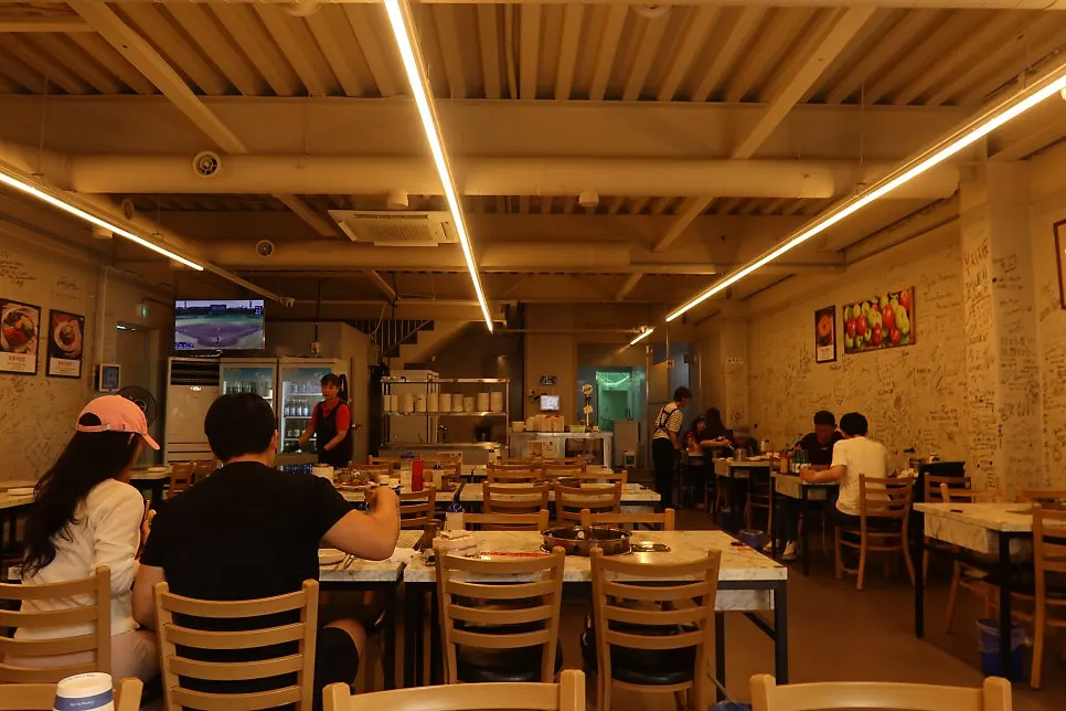 Baby looking at the live octopus tank inside the restaurant