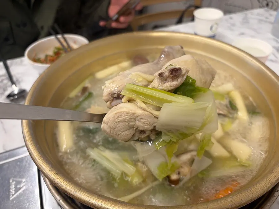 Ladle scooping up dak hanmari broth