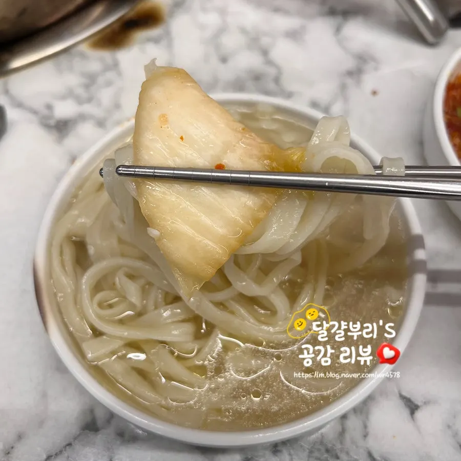 Dak hanmari broth topped with noodle sari and kimchi