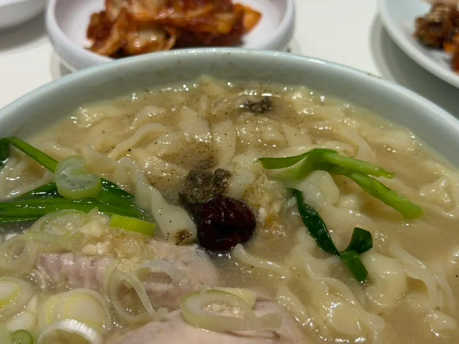 Handmade kalguksu noodles lifted out of the bowl