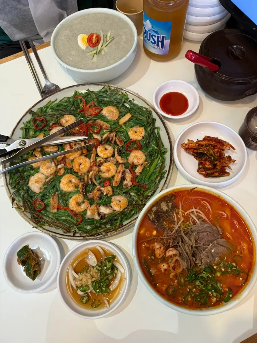Table spread with kalguksu and chive pancake served together