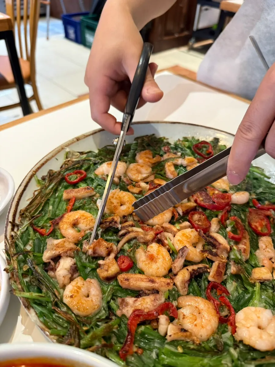 Surface of the pancake topped with shrimp and squid