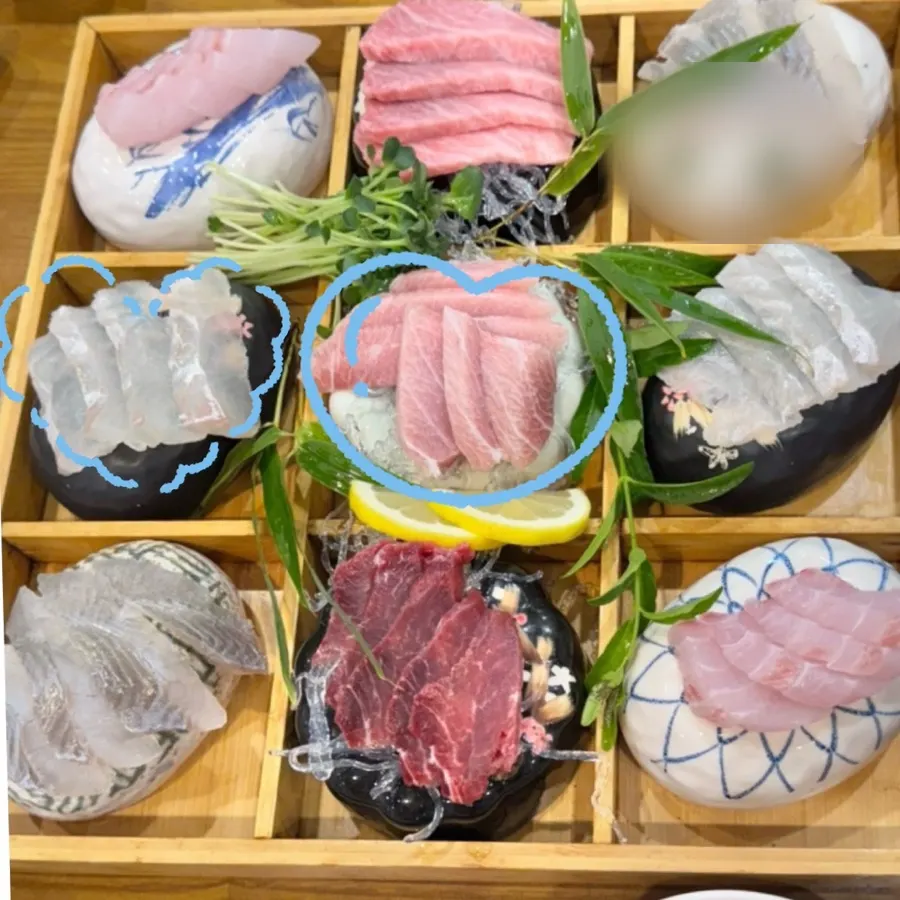 The mixed sashimi platter for four, arranged neatly on stone