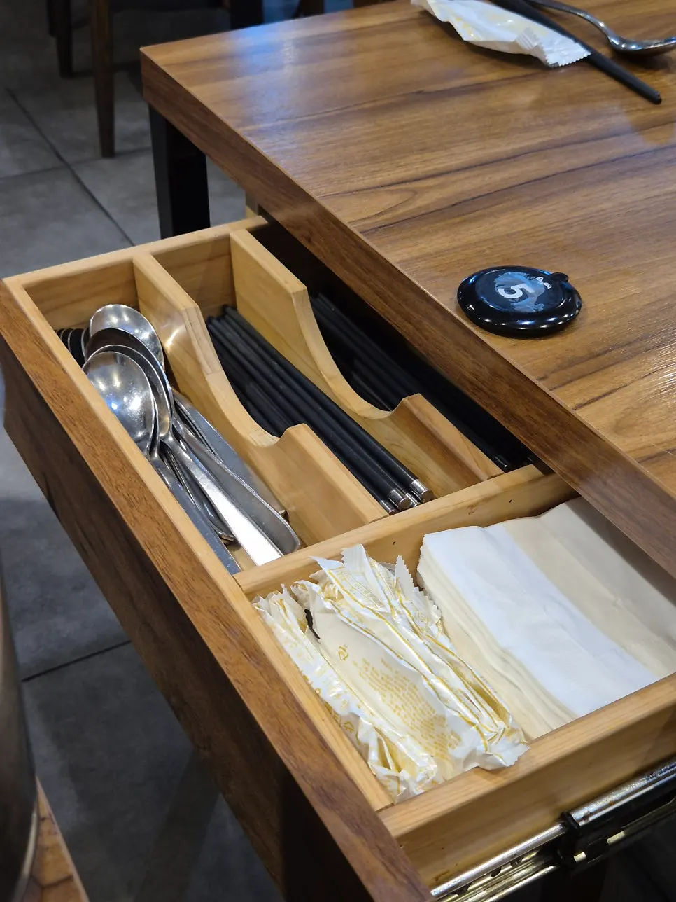 Soy sauce and chogochujang on the table, chopsticks in the drawer