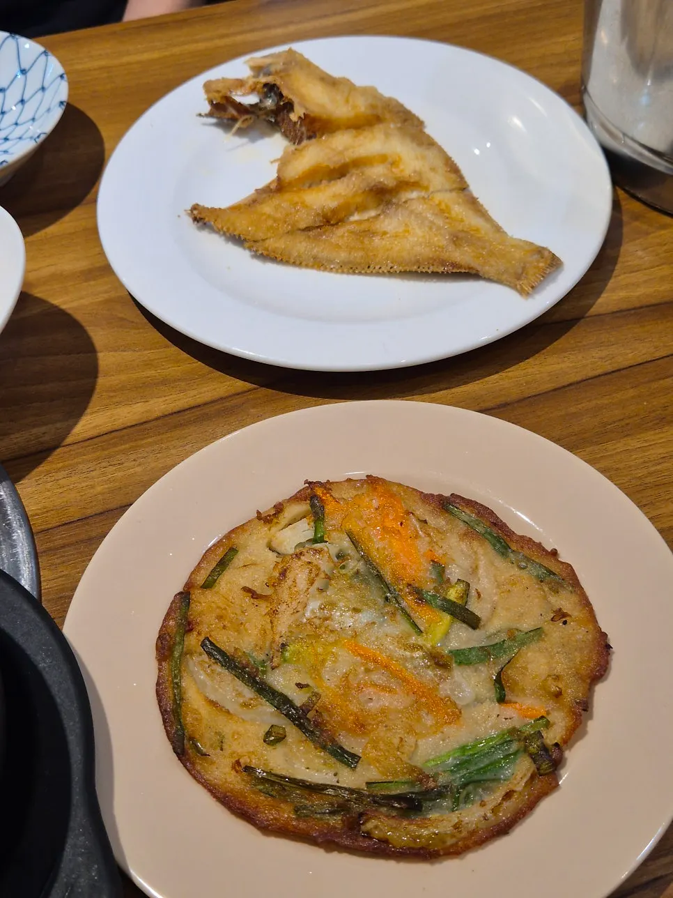 Side dishes including aged kimchi, silkworm pupae and grilled fish