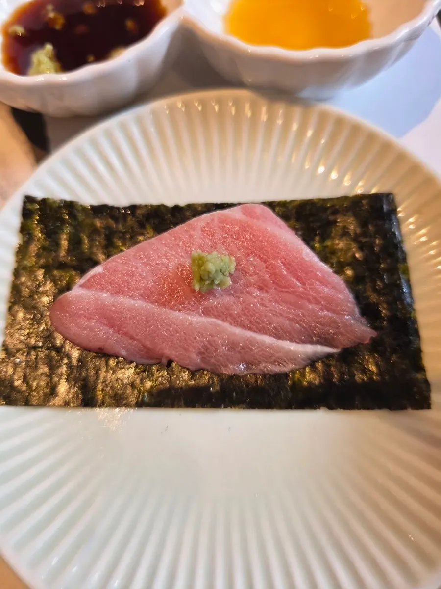 Aged tuna sashimi dipped in soy sauce and sesame oil sauce