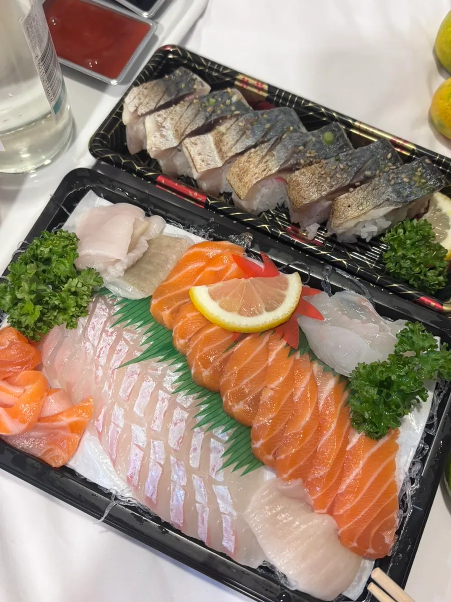 Thickly sliced salmon and flatfish sashimi takeout on a plate