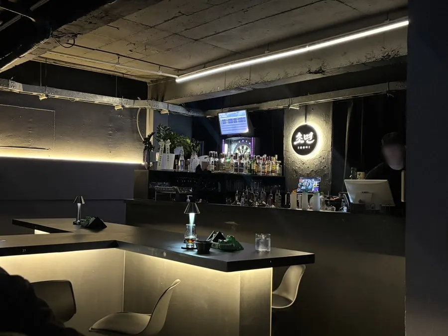 Interior of Chomyeon with videos playing on a large screen
