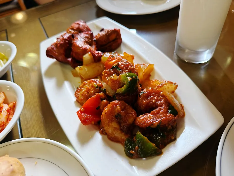Chicken tikka and shrimp chili served on one plate