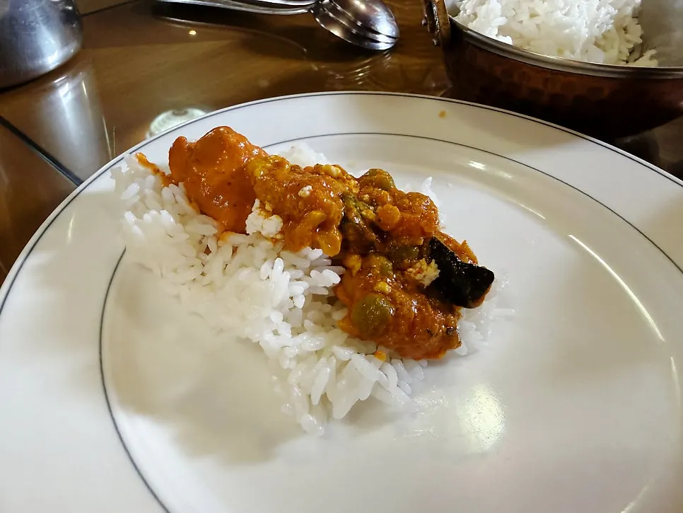 Curry spooned over fluffy rice