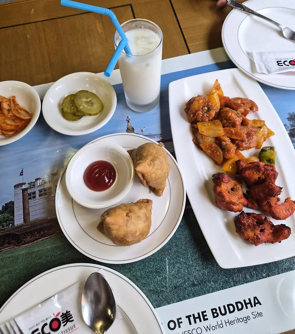 Table spread with momo dumplings, chili shrimp and tandoori chicken