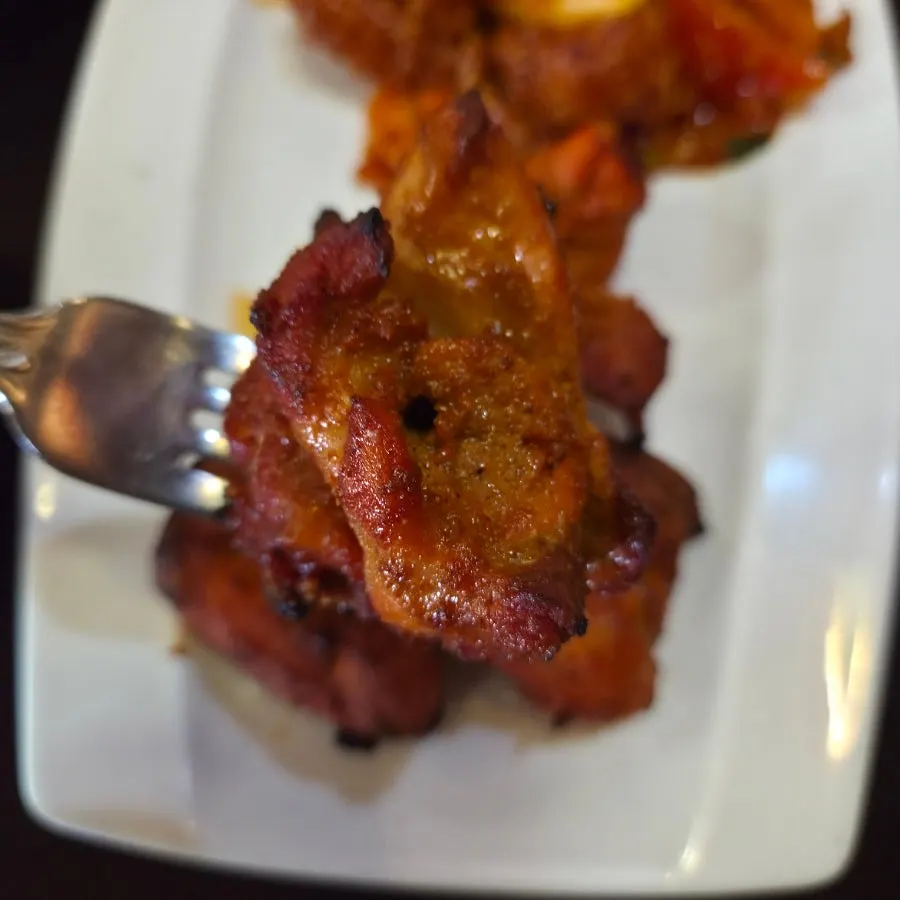 A plate of grilled chicken tikka