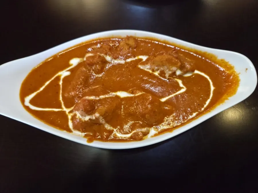 A bowl of mild chicken makhani curry