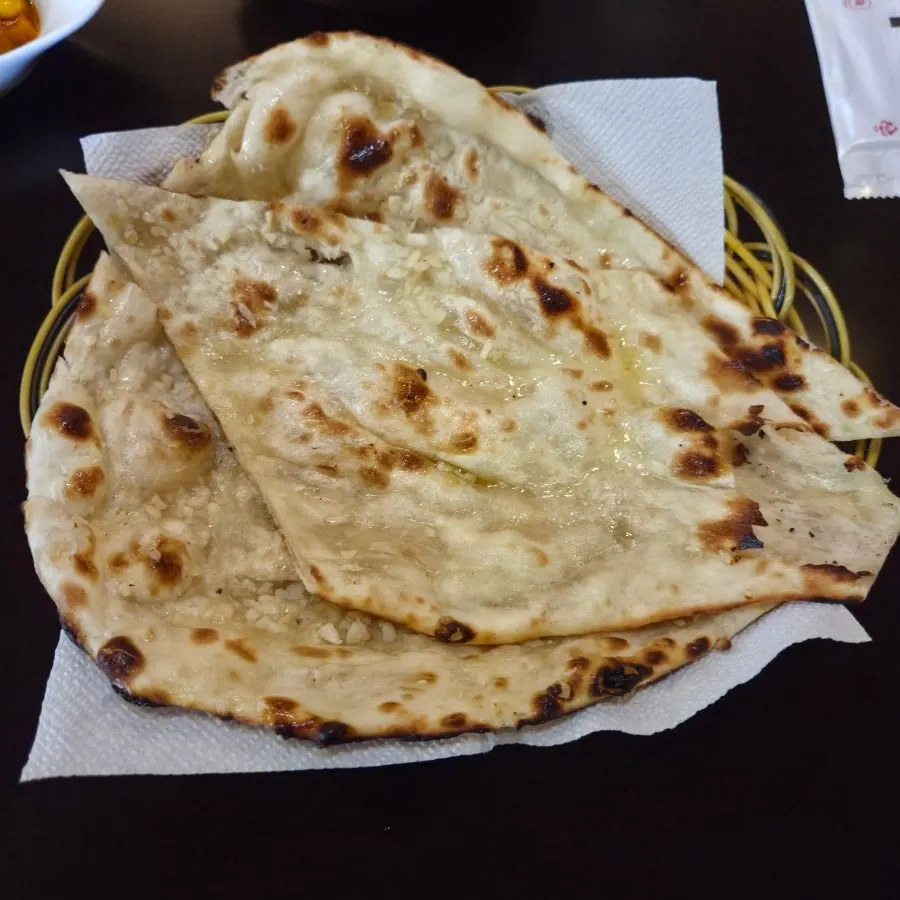 Naan served alongside the curry