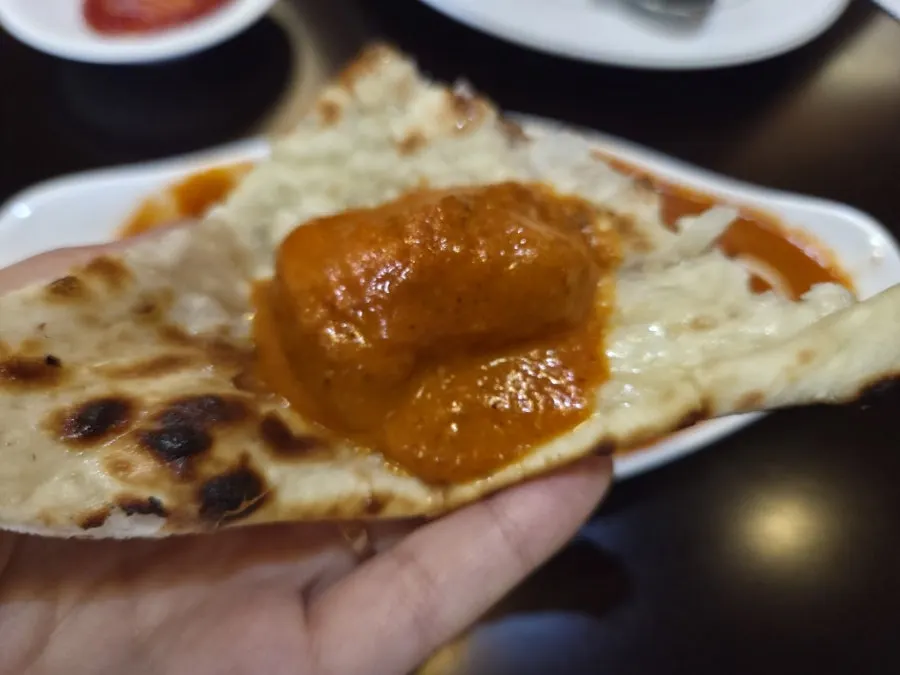 Chicken makhani curry piled onto naan