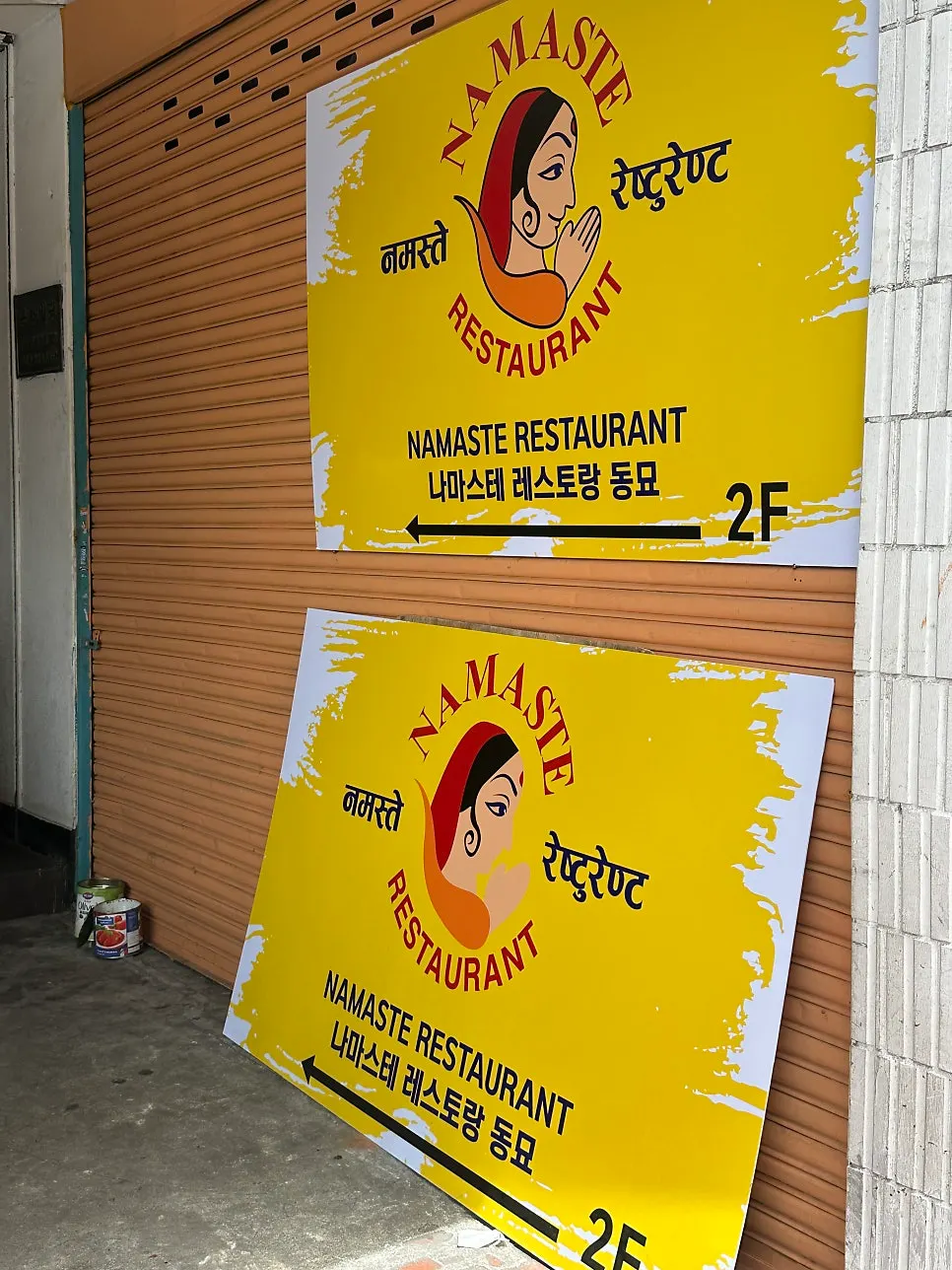 Menu signboard for Namaste Dongmyo Branch set up in front of the building