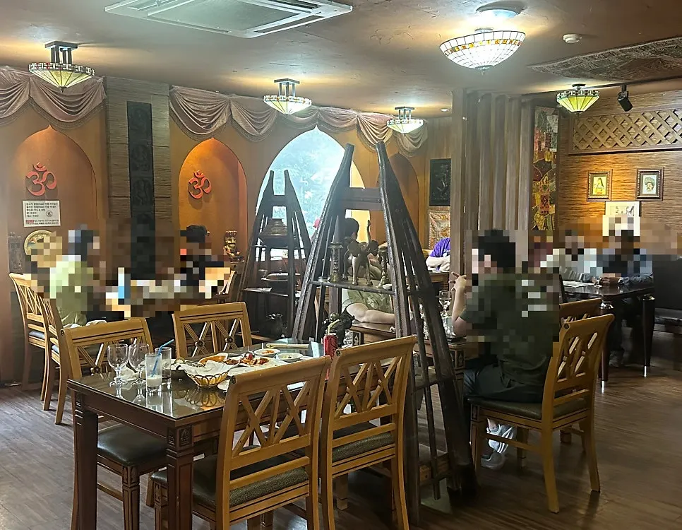 Interior of Namaste Dongmyo Branch lined with tables