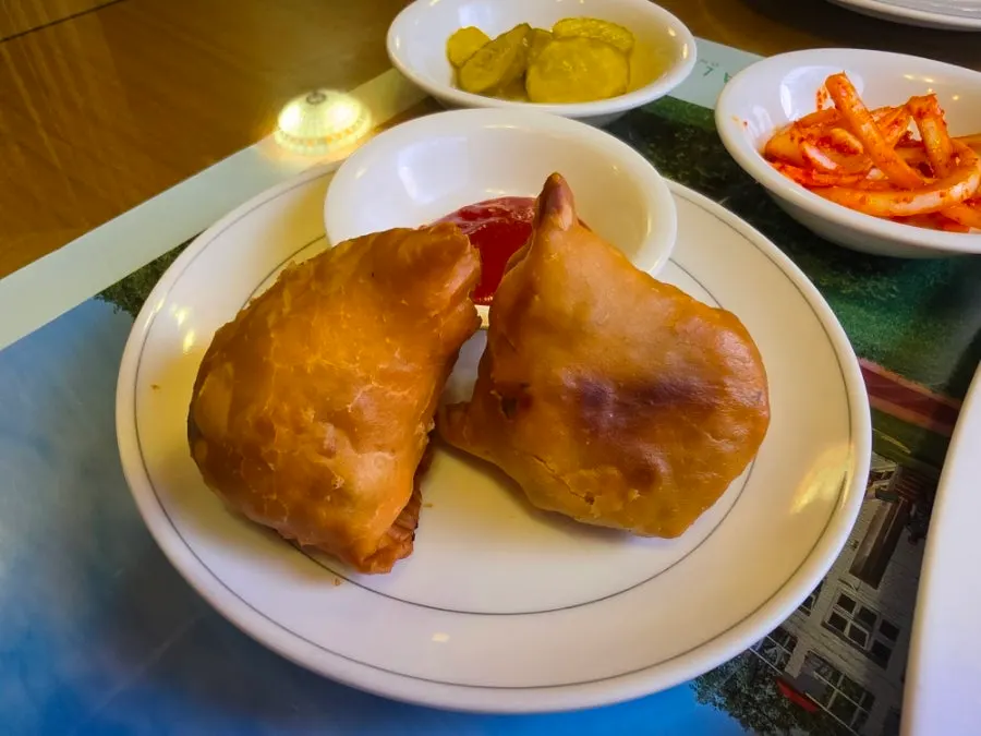 Two crispy fried samosas