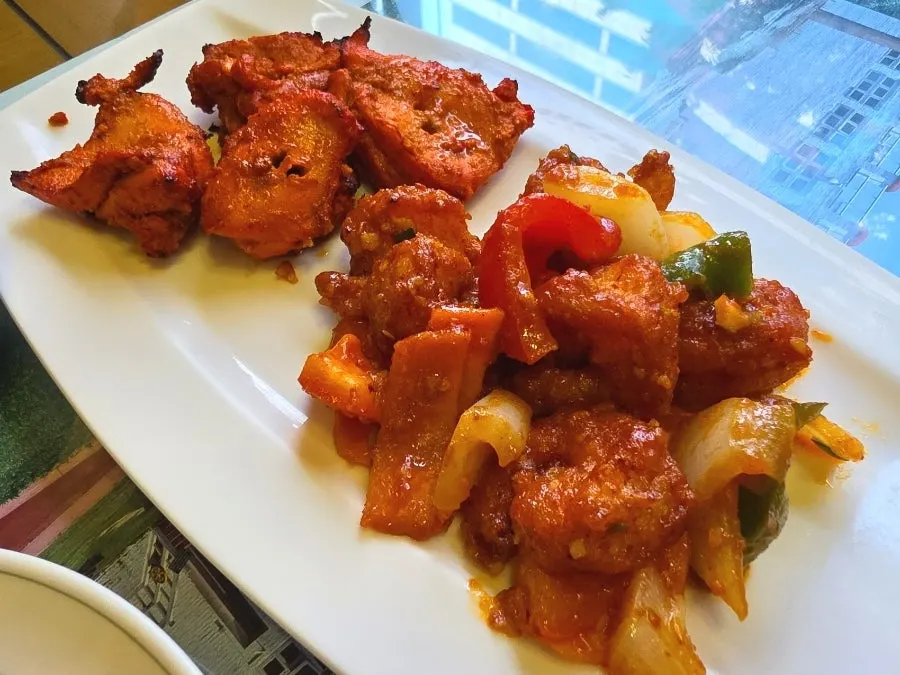 Chicken tikka and shrimp chili on one plate
